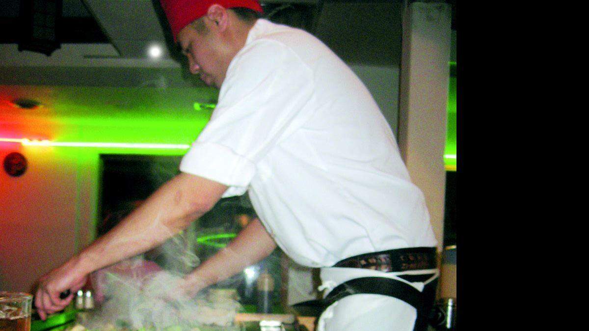 Combination dinner of filet and lobster fills the entire plate at Sasaki Japanese Steak House in Lake Wylie as the chef finishes preparing other diners' meals at the table.