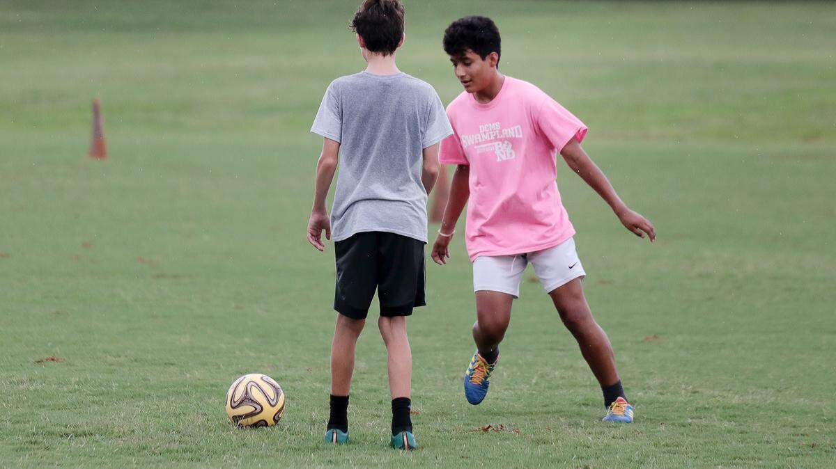 14-year-old Alden Weeks, left, and 13-year-old Justin Cruz sweat it out on the soccer field Monday at Winthrop Lake.