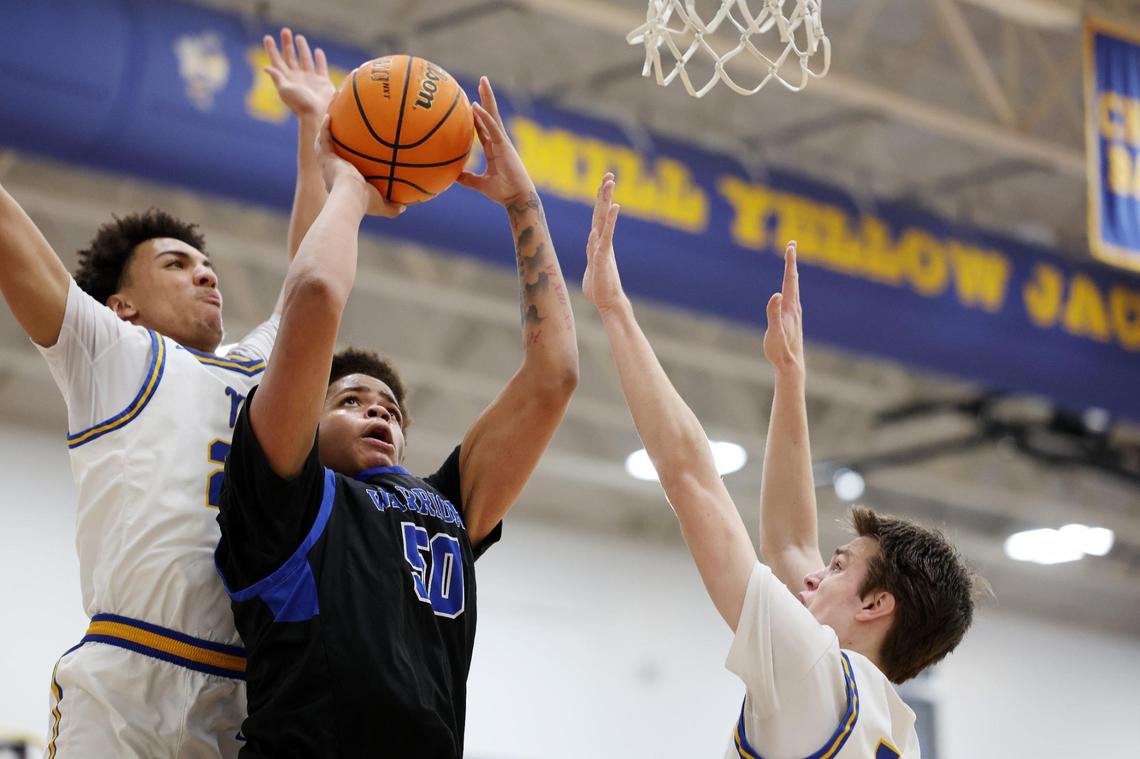 Indian Land’s Jayden Williams shoots the ball as Fort Mill’s Noah Johnson, left, and Wallace Campbell defend Wednesday in Fort Mill.