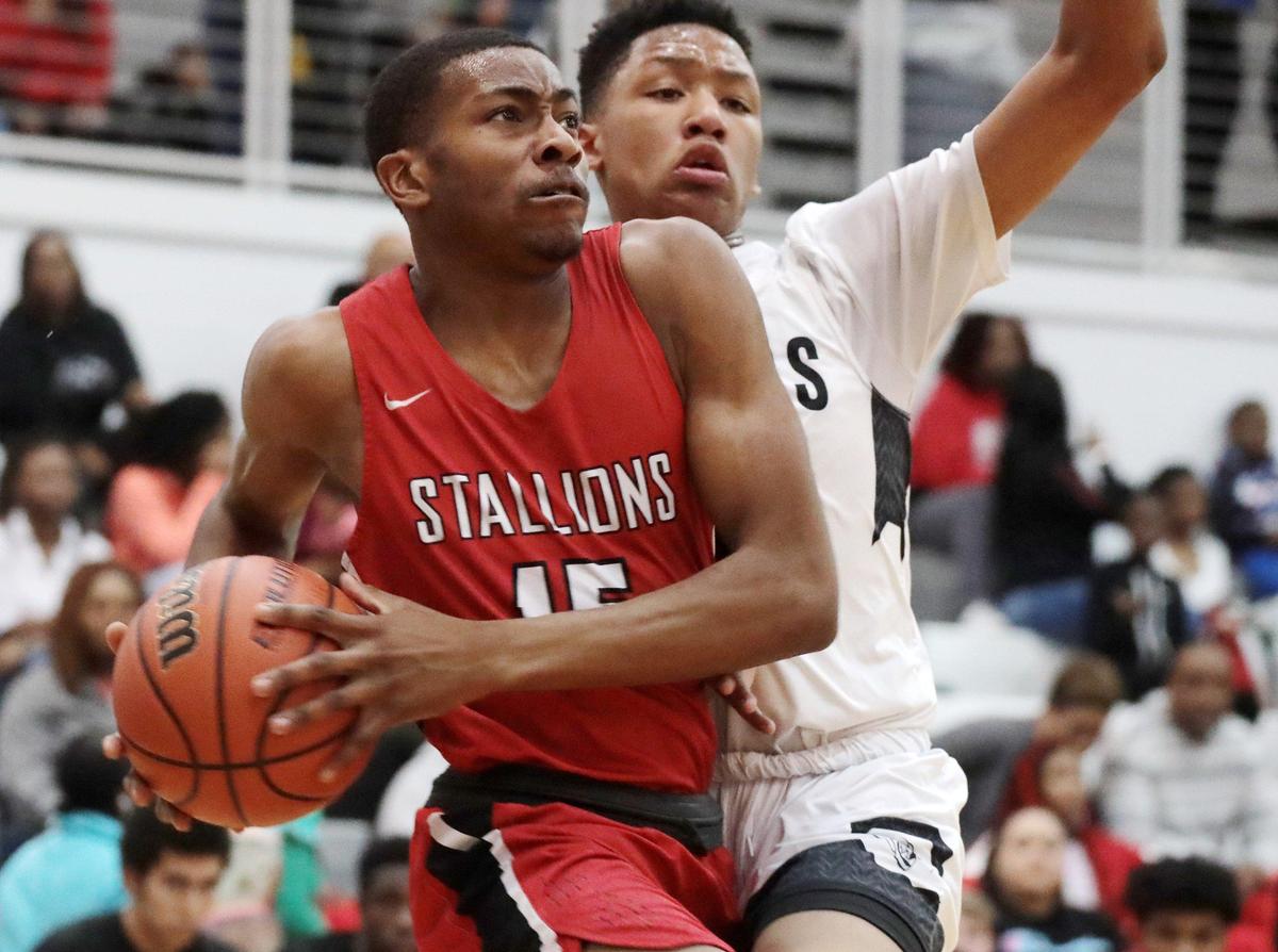 South Pointe’s Jerijah Burris heads to the basket around York’s T.J. Burrett Friday at York Comprehensive High School.