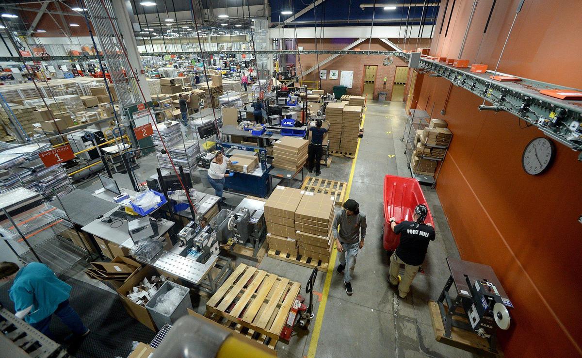Workers in the shipping department prepare products at Shutterfly in Fort Mill, S.C. The facility is a sprawling network of departments dedicated to printing photo products for their customers. During the holiday season, Shutterfly expands from about 350 workers to about 1,000.