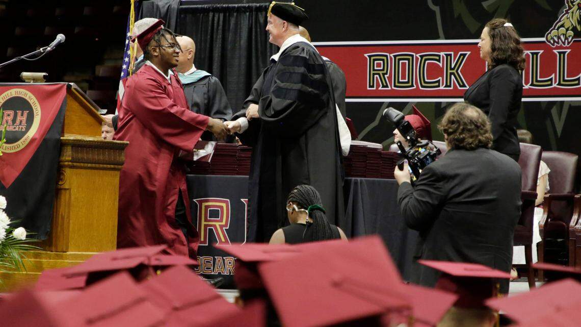 A student shakes hands with Rock Hill Schools Superintendent Tommy Schmolze this summer at the Rock Hill High School graduation ceremony at Winthrop Coliseum.