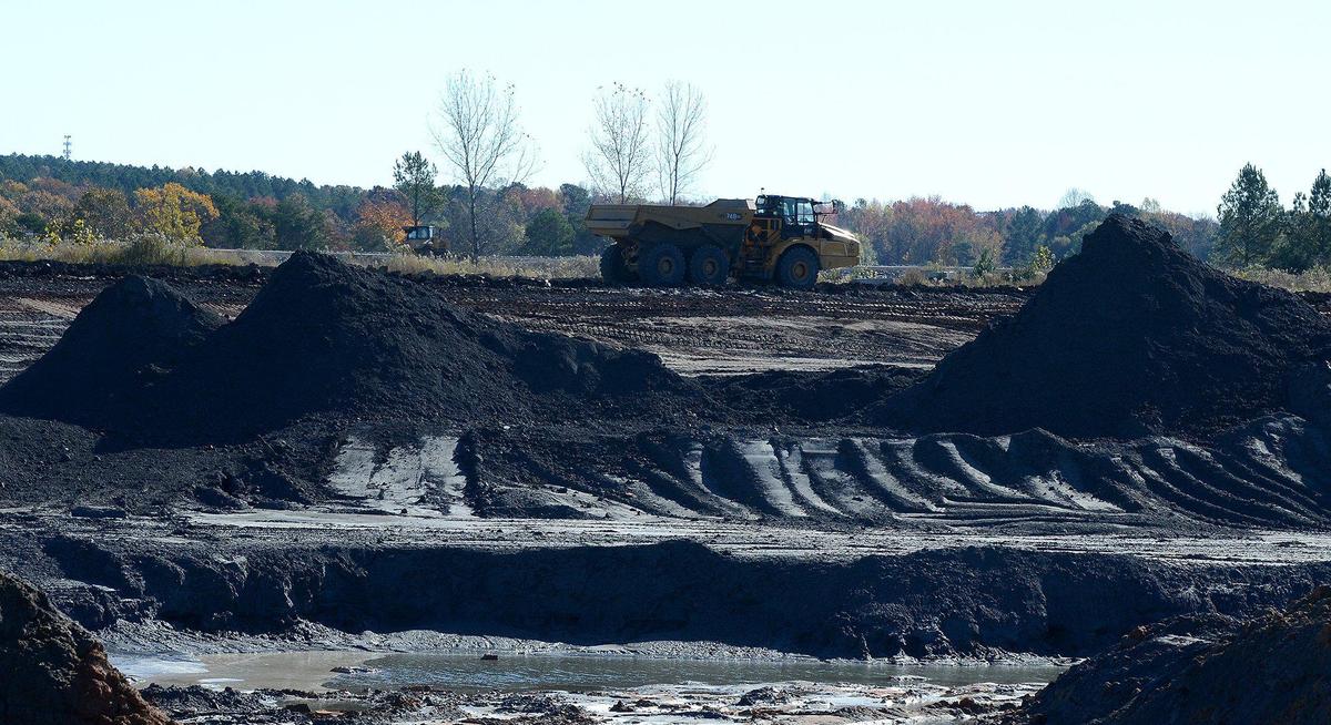 Work goes on at the active ash basin at the Allen Steam Station. Coal ash will be buried in double-lined landfills at the Gaston County site on Lake Wylie.