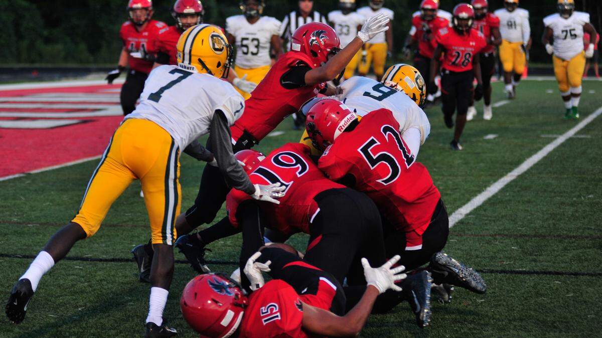 The Nation Ford Falcons try to keep Conway junior Tate Finklea out of the endzone during their home opener on August 24. The Tigers led the Falcons 10-0 at the half.