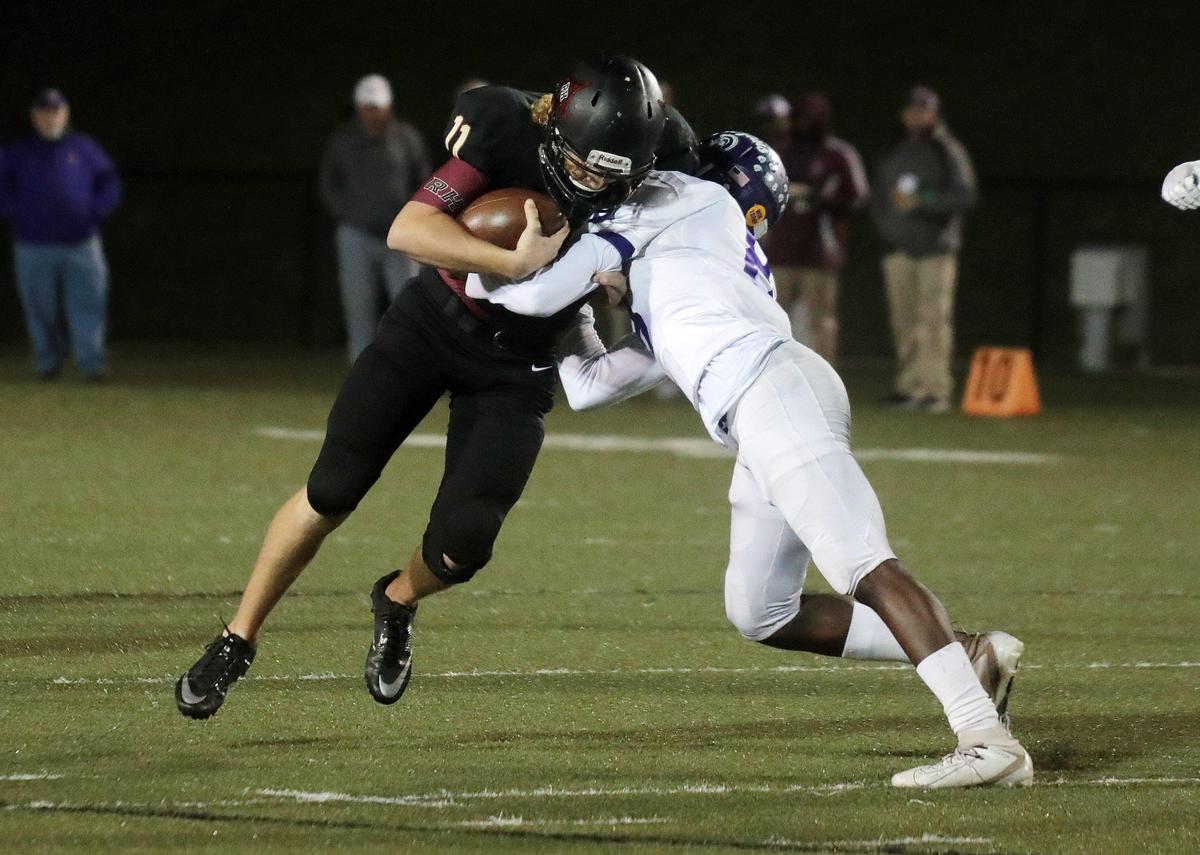 Rock Hill’s Jackson Roberson (11) is stopped by Northwestern’s Jalon Mickle during the cross-town rivalry game at District Three Stadium.