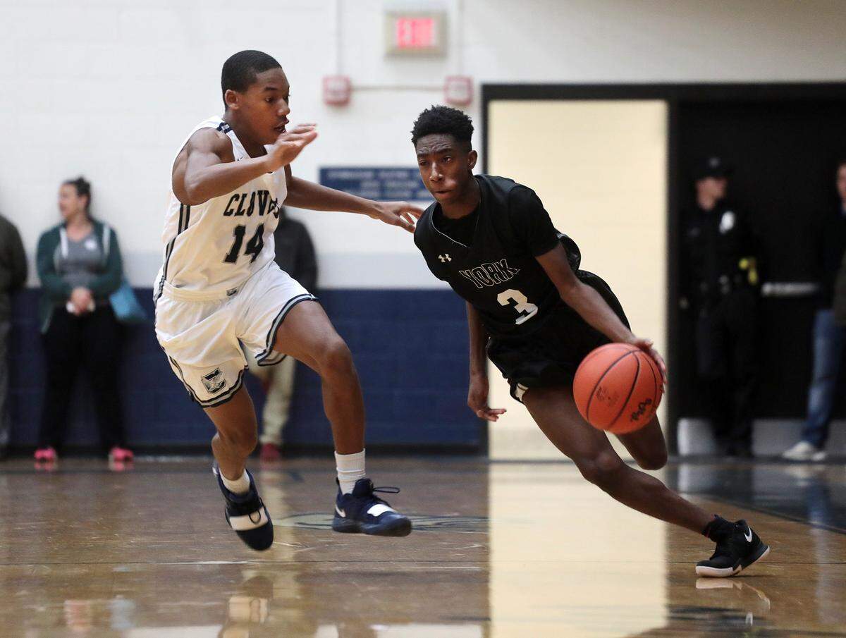 York’s Jevon Long drives to the basket around Clover’s Jaylin Lane.