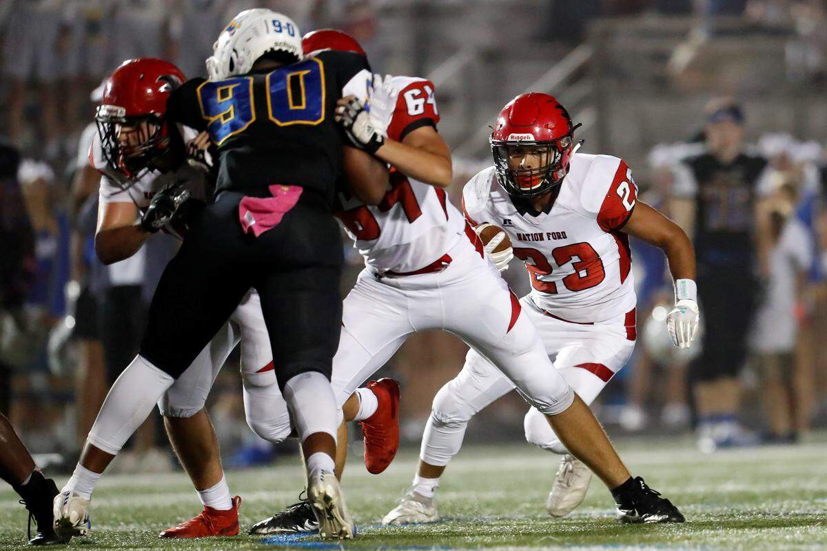 Nation Ford’s Nathan Mahaffey (23) carries the ball Friday as Fort Mill hosts Nation Ford in a cross town football rivalry.