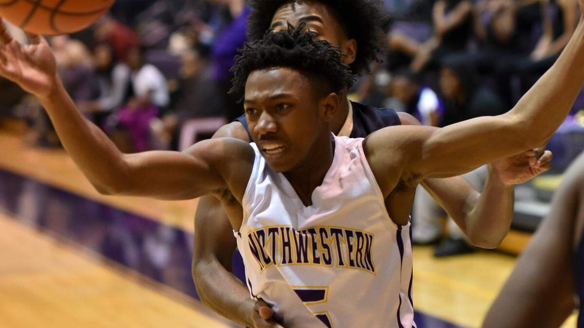 Zuric Harvey makes a pass during the Trojans’ AAAAA playoff game at home Saturday night, Feb. 16. Northwestern lost to Spartanburg 58-60.