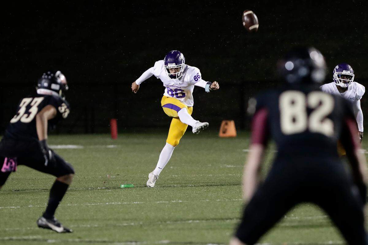 Northwestern’s (86) Kanoah Vinesett kicks off after a Trojan touchdown in the first half as Northwestern takes on Rock Hill in Friday night varsity football action, 10-29-2021.