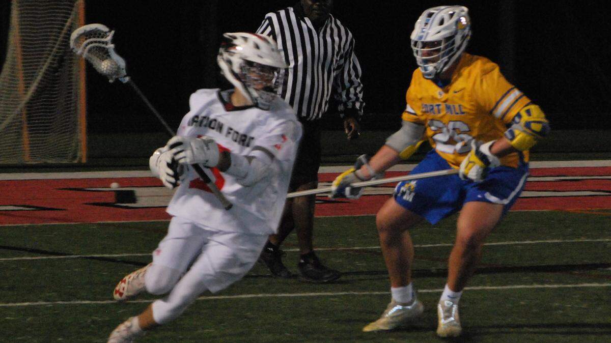 Nation Ford’s Tyler Demarco, left, looks to get around Fort Mill’s James Hyland during a recent game between the two rivals.