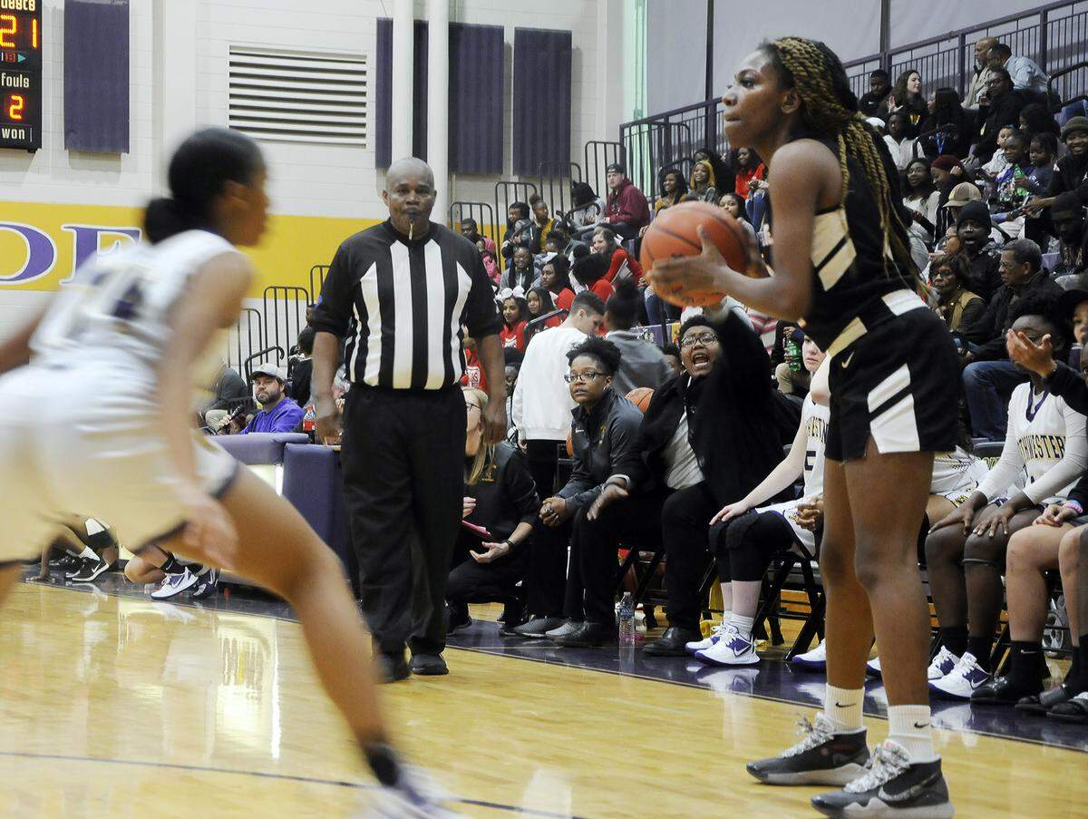 South Pointe’s Jaliyah Gaiton surveys the court as she gets pressured by a Northwestern defender in the season opening game on Monday, Dec. 2.