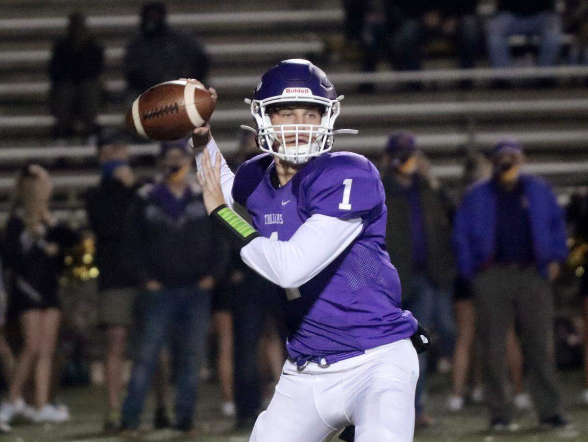 Northwestern quarterback Will Mattison looks for an opening Friday as the Trojans take on the T.L. Hanna Yellow Jackets at the SC semi-finals in Rock Hill.