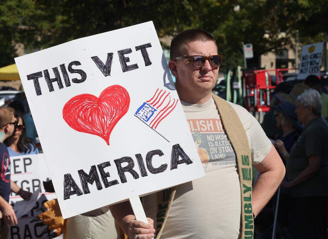A protester holds a sign at the downtown Rock Hill ‘No Kings’ rally on Saturday, Oct. 18.