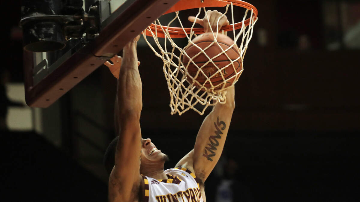 Winthrop’s Josh Ferguson slam dunks the ball.