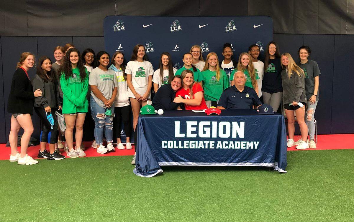 The Legion Collegiate Academy softball team gathers for a picture to honor its senior, Reagan Smith, who signed to play softball at Newberry on Wednesday.
