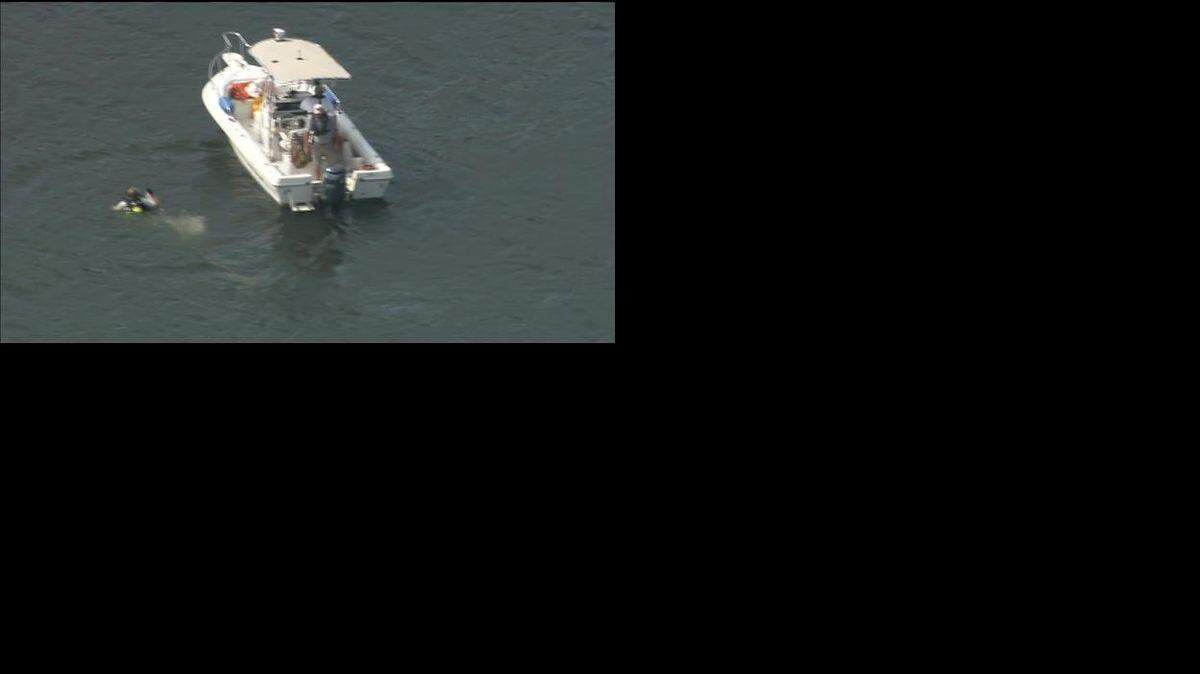 A dive team searches for a missing swimmer Monday afternoon near Windjammer Park in Tega Cay.
