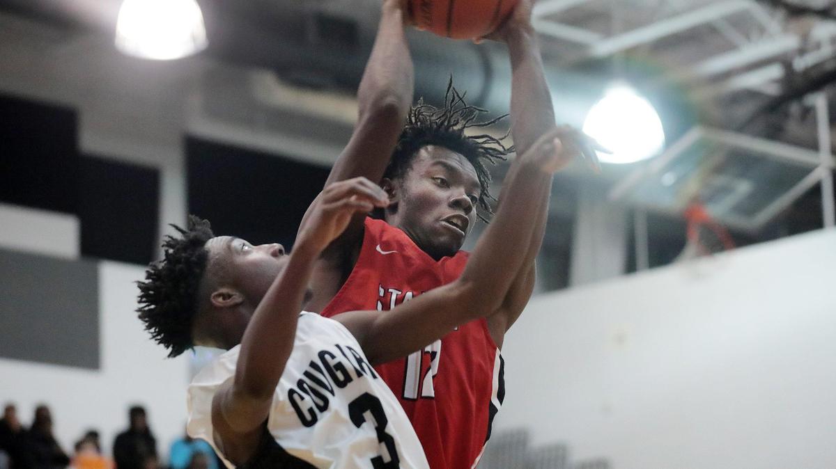South Pointe’s Montae Joseph grabs the rebound away from York’s Jeron Long Friday at York Comprehensive High School.