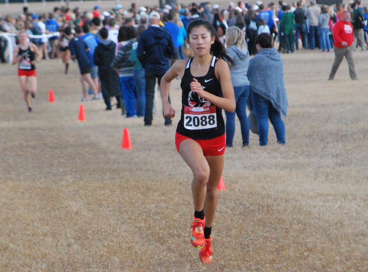 Nation Ford’s Katie Pou extends her lead during the 5A girls state cross country meet in Camden. Pou won her third straight 5A state title.