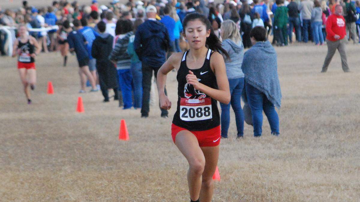 Nation Ford’s Katie Pou extends her lead during the 5A girls state cross country meet in Camden. Pou won her third straight 5A state title.