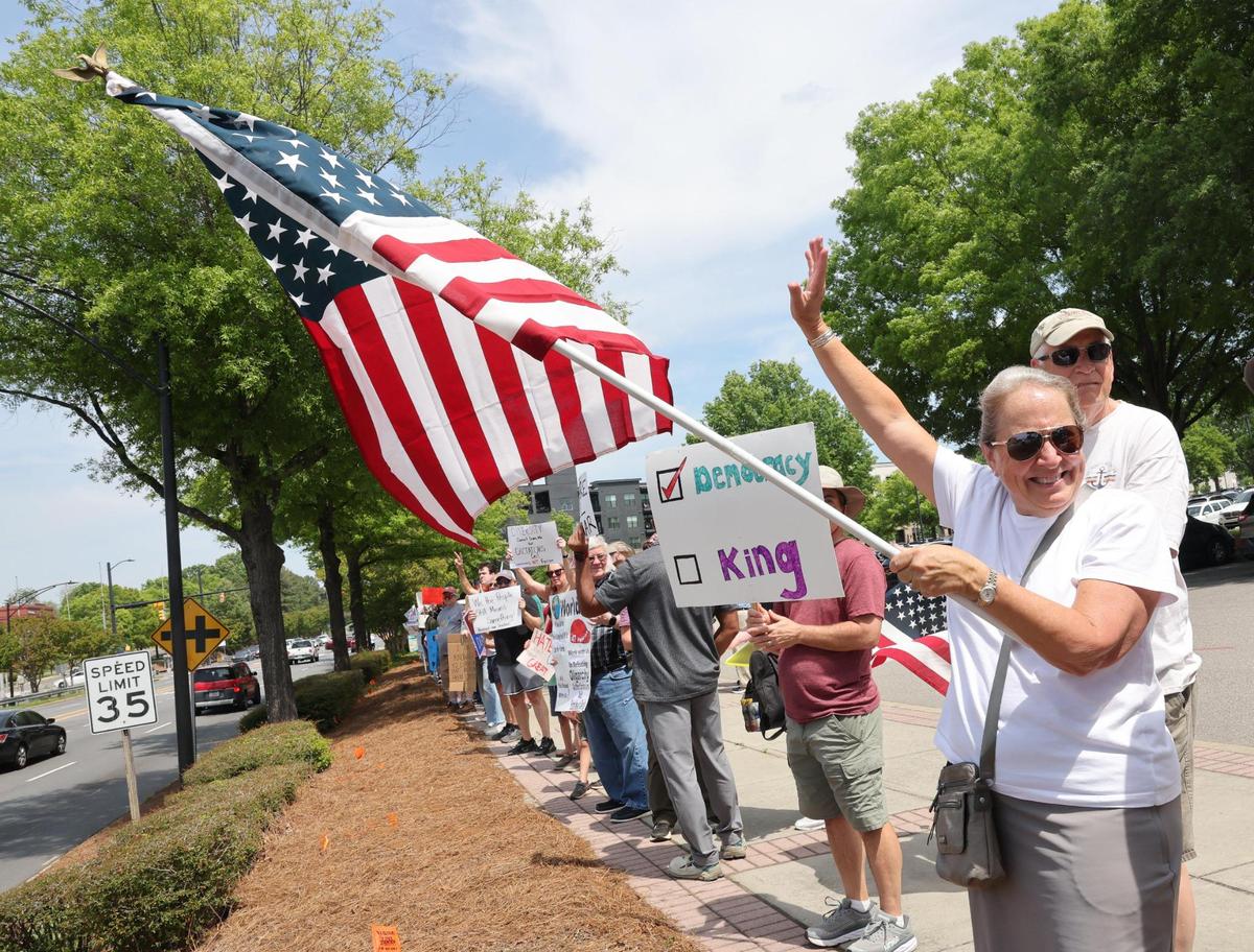 Demonstrators with York County Rising protest President Trump and his policies Sautrday in downtown Rock Hill.