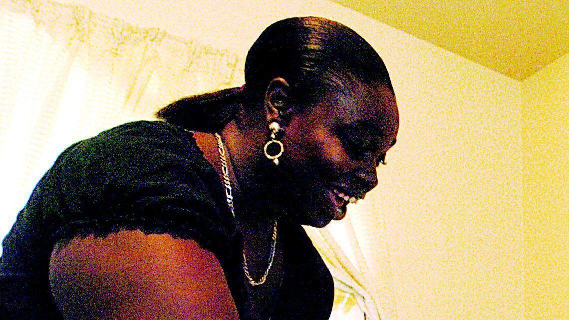 Kisha Lockhart checks on her son, Dondre, 13, while he does his math homework.