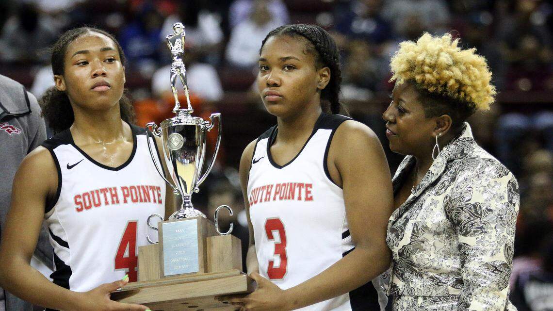 South Pointe’s Scarlett Gilmore, Jamia Blake and coach Stephanie Butler-Graham accept the runner-up trophy after state championship loss to North Augusta.