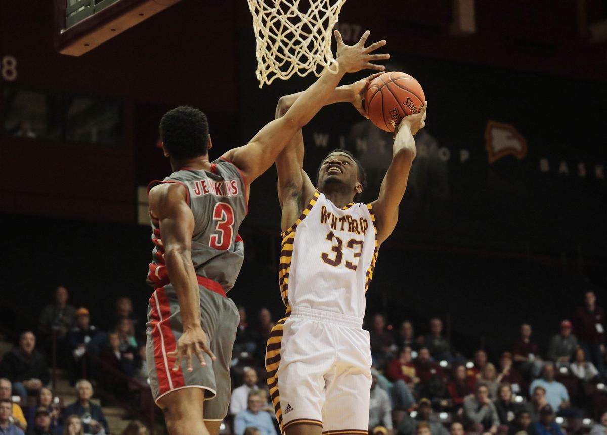 Winthrop’s Chase Claxton is fouled by Gardner-Webb’s Justin Jenkins Saturday as the Eagles take on the Bulldogs at the Winthrop Coliseum.