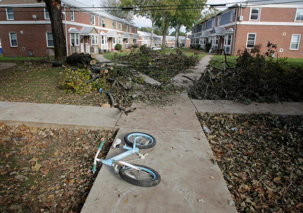 A child’s bicycle lays near fallen tree branches at Pisgah View apartments in Asheville, NC on Oct. 3, 2024. Tropical Storm Helene devastated Western North Carolina in late September.