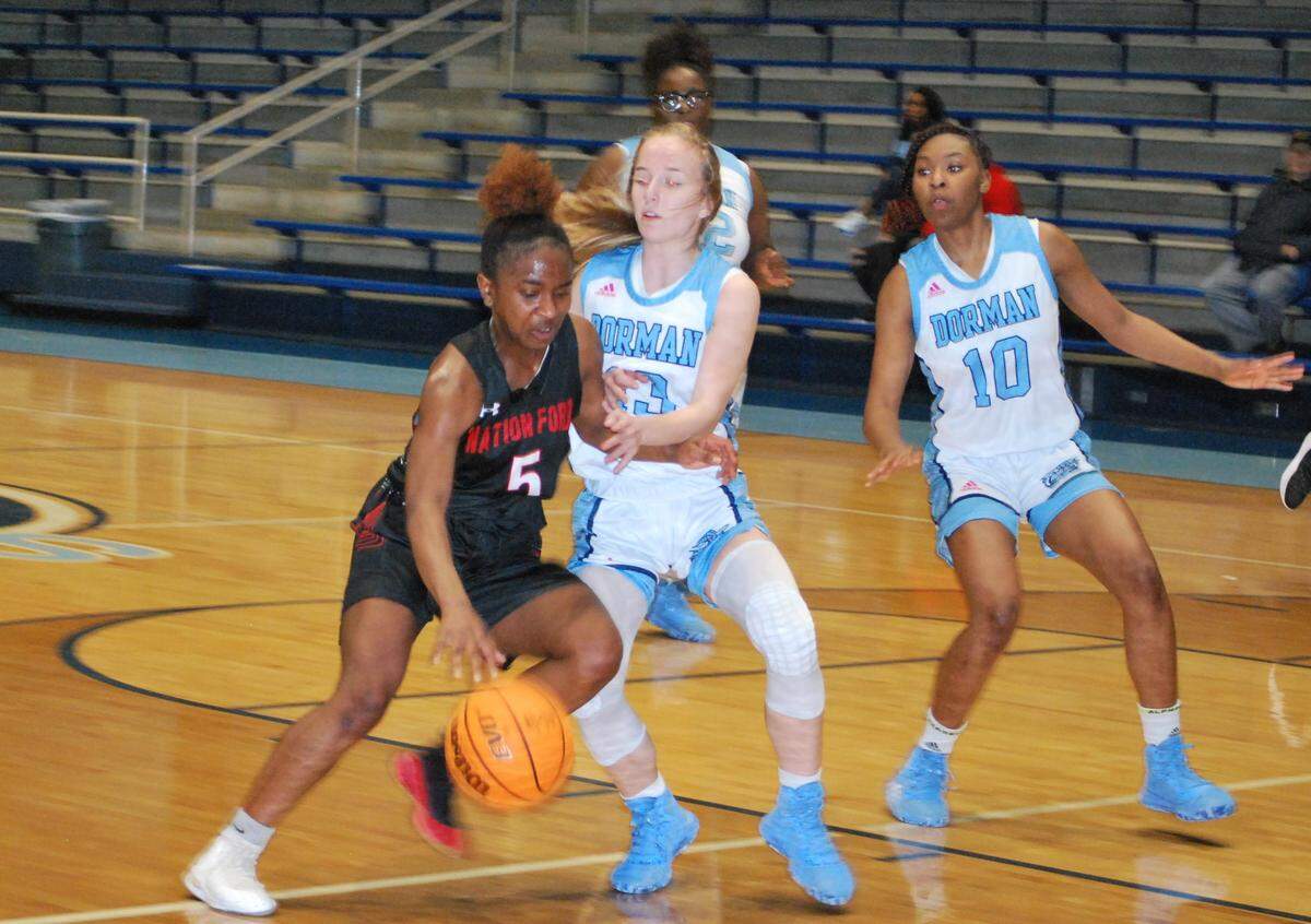 Nation Ford’s Denaundria Greene drives to the basket during the Falcons’ first round 5A playoff game against Dorman.