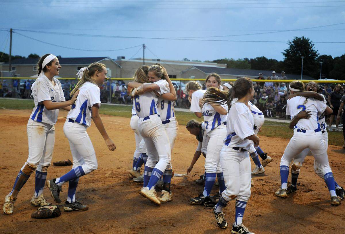 The Lewisville High School softball team celebrates after winning the Class 1A 2018 state championship in Richburg.