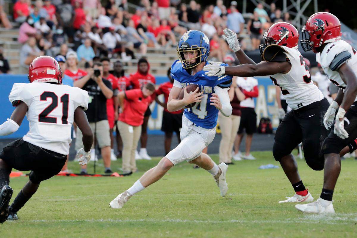 Indian Land quarterback (14) Blake Goode keeps the ball for a touchdown in first quarter action as Indian Land hosts Nation Ford in Friday night football action. 8-20-2021.