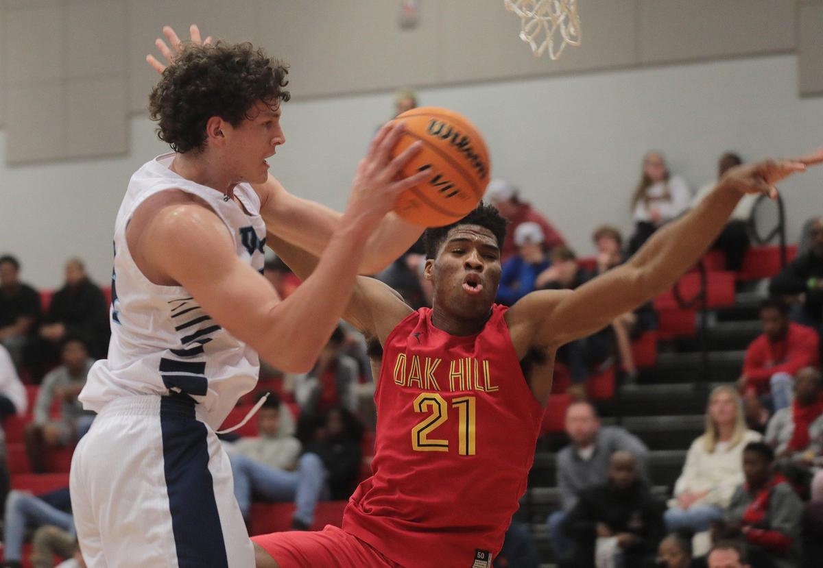 Dorman’s P.J. Hall pulls down the ball against Oak Hill’s Emmanuel Okpomo Thursday at the Battle at the Rock at Nation Ford High School.