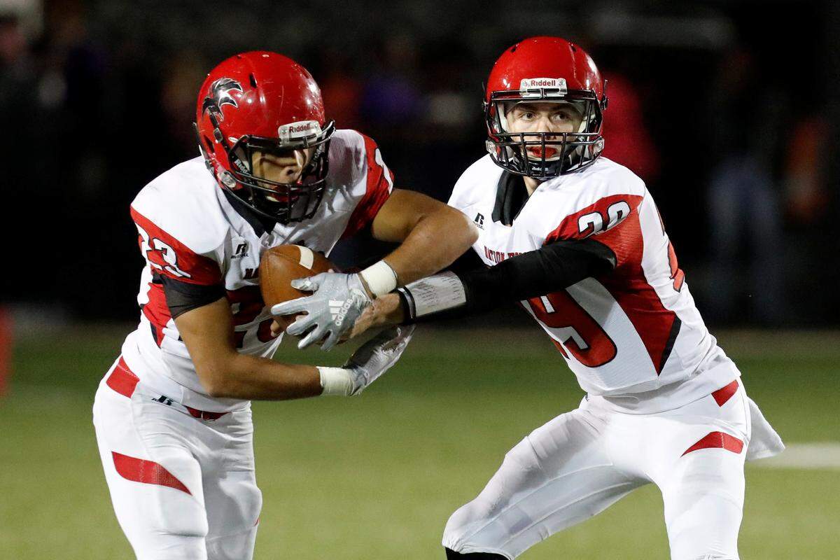 Nation Ford quarterback #29 Tyler Nelson hands the ball to #23 Nathan Mahaffey as Northwestern defeats Nation Ford in a second half nail biter, Friday 10-12-2018.