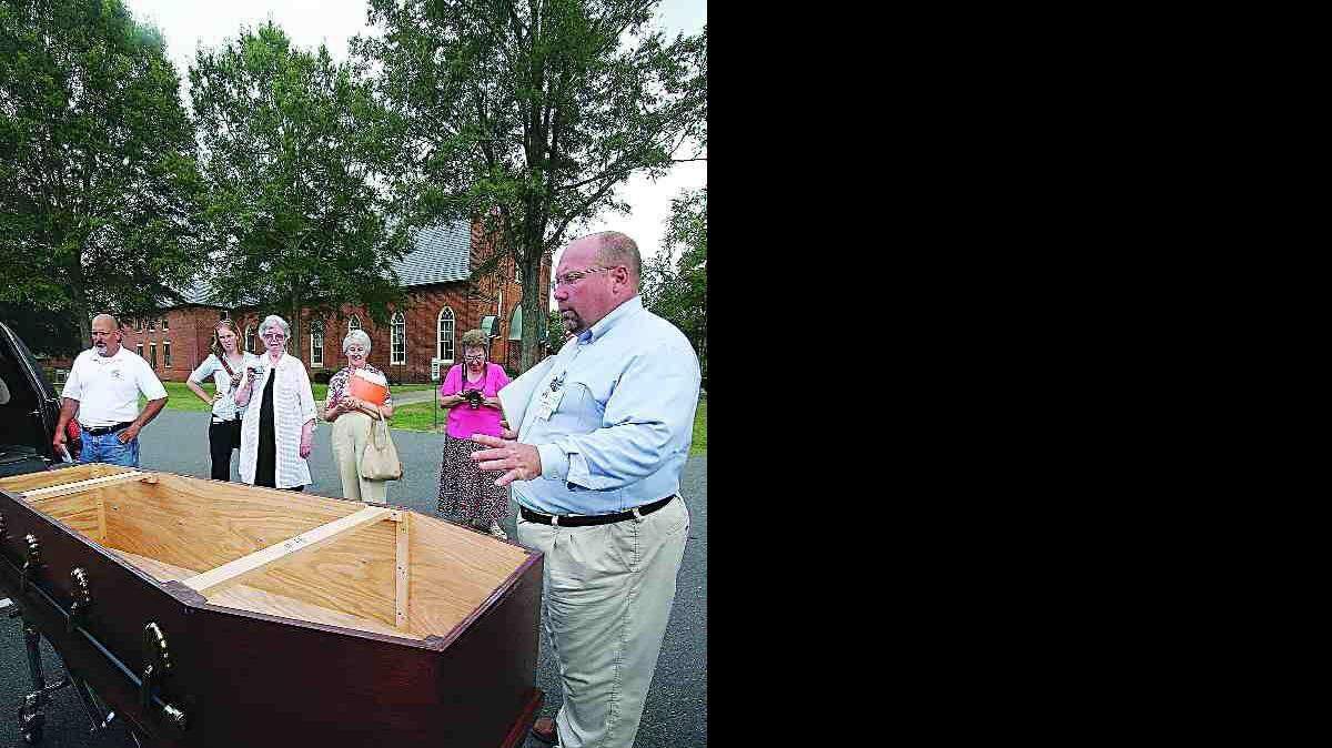 Bill Merritt of Carolinas Medical Center shows descendants of Thomas Spratt's family a coffin he built to bury remains of Spratt ancestors who were buried in Charlotte and will be reburied at the Steele Creek Presbyterian Church on Saturday.