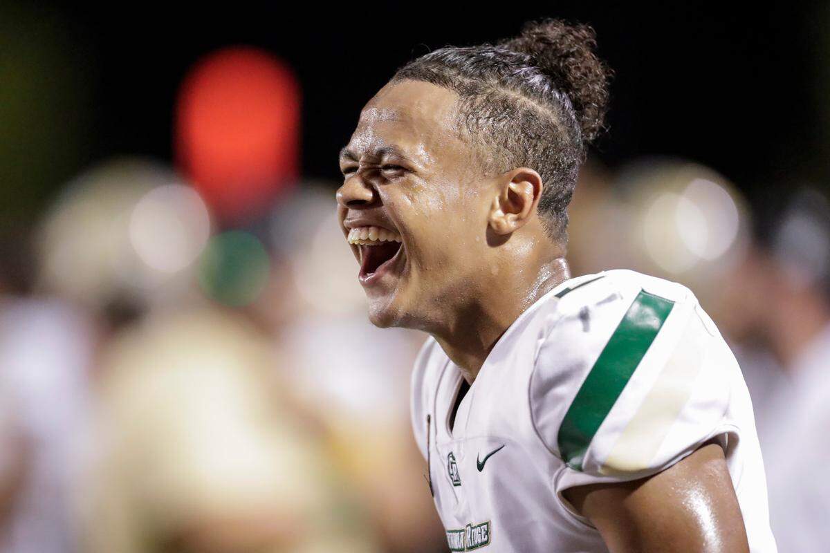 After taking control of the game in the second half, Catawba Ridge quarterback (2) Jadyn Davis enjoys a laugh on the sideline as Nation Ford hosts Catawba Ridge in a Friday night cross town football rivalry, 8-27-2021.