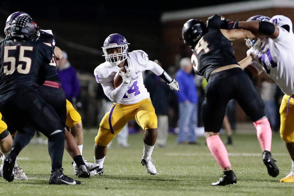 Northwestern’s (14) Turbo Richard finds the hole and runs for a gain as Northwestern takes on Rock Hill in Friday night varsity football action, 10-29-2021.
