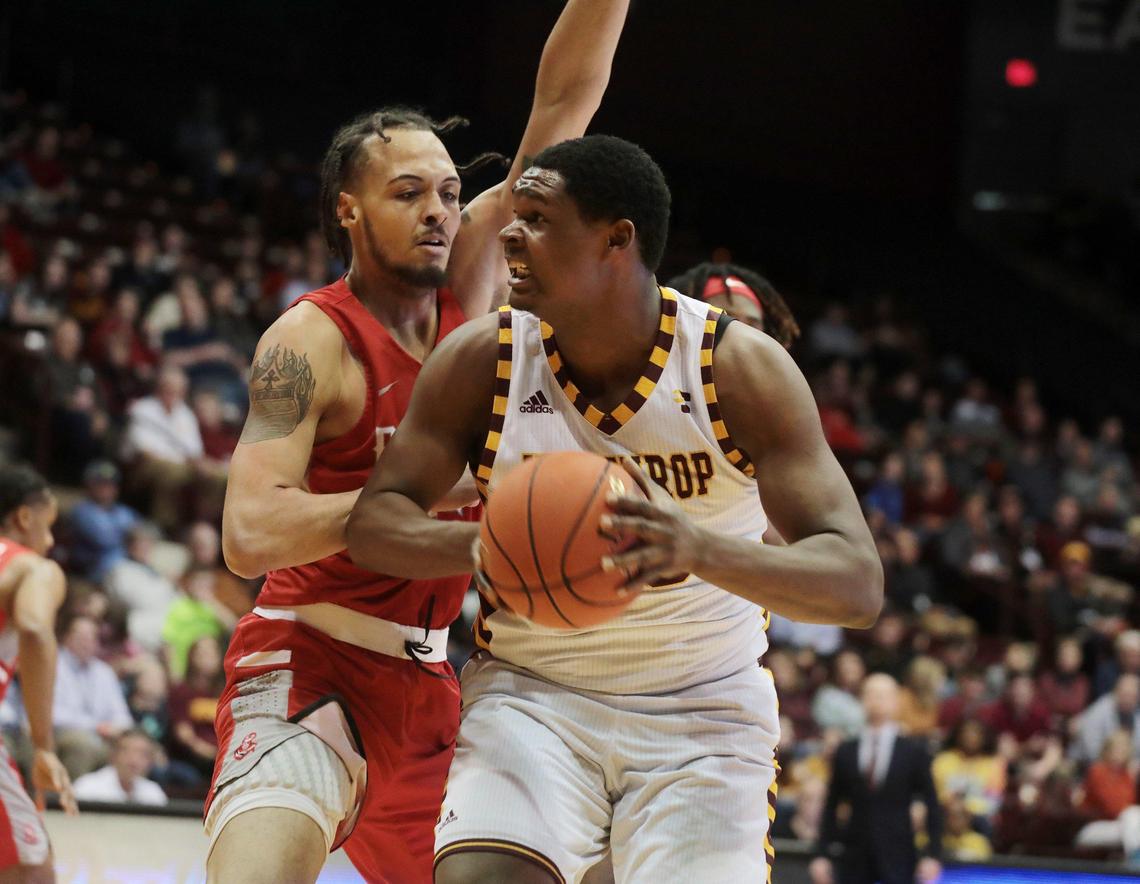 Winthrop’s D.J. Burns looks for an opening around Radford’s Chyree Walker as the Eagles take on the Highlanders at the Winthrop Coliseum on Monday, Feb. 10, 2020.