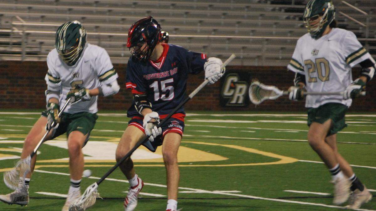 Members of the Catawba Ridge and Providence Day lacrosse teams fight for possession during the Copperheads’ first-ever lacrosse game on Tuesday, Feb. 25, 2020.