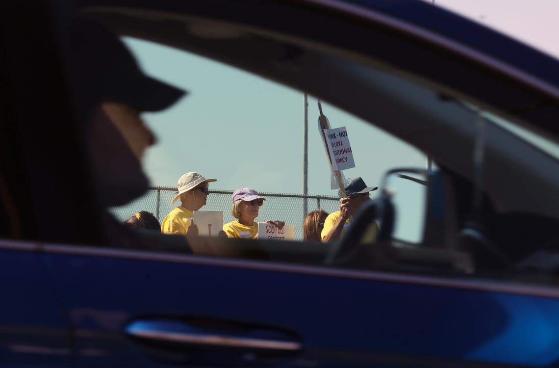 Cars passed by as hundreds of Indian Land and Fort Mill residents gathered across the street from Indian Land Middle School on Saturday, Oct. 18, as part of the national ‘No Kings’ protests against President Donald Trump.