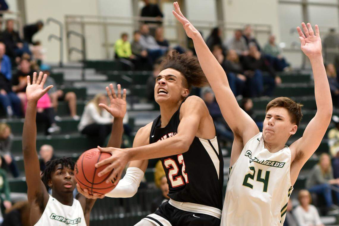 Great Falls senior Kelton Talford pushes past Catawba Ridge’s Luke Krawczyk to put the ball in the basket Monday night at Catawba Ridge.