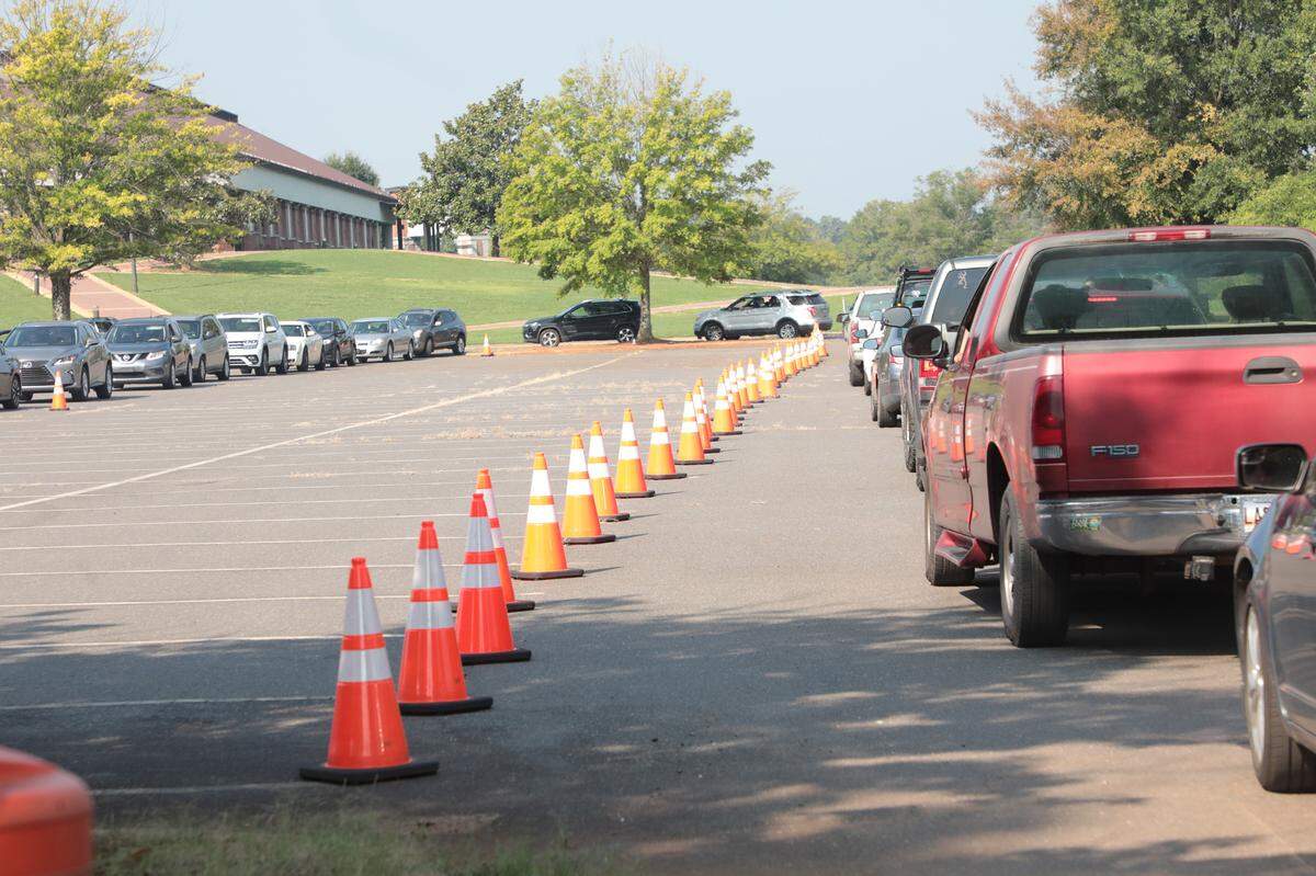 A long line of cars snakes its way through the Winthrop Coliseum parking lot Wednesday at a Covid testing site. The line extended down Eden Terrace.