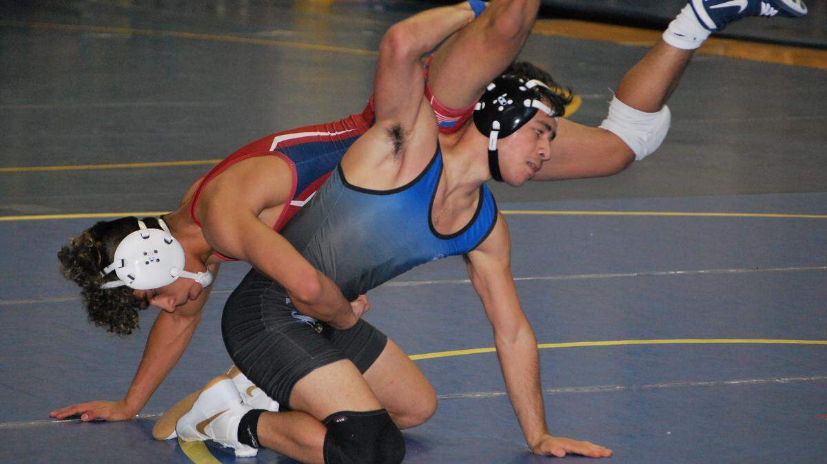 Fort Mill’s Sebastian Colon looks to get away from his White Knoll opponent during their match at the Wildcat Duals in Lexington.