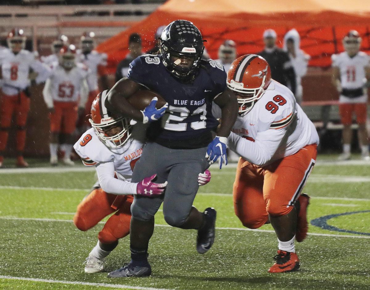 Clover’s David Hall (23) is brought down by Mauldin’s Javan Wilson (9) and Jesse Mansell (99) as the Blue Eagles take on the Mavericks in Clover Friday.