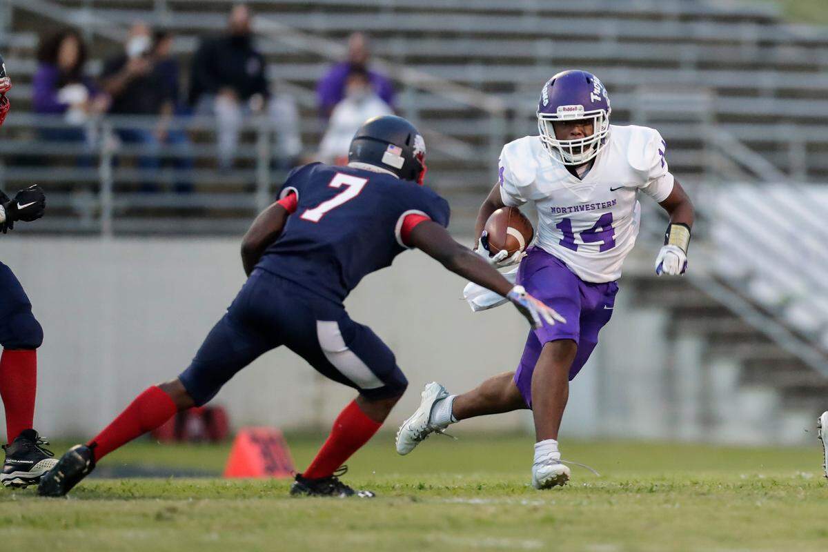 Northwestern’s (14) Turbbo Richard carries the ball in the first quarter as Chester hosts Northwestern in Friday night football 9-10-2021.