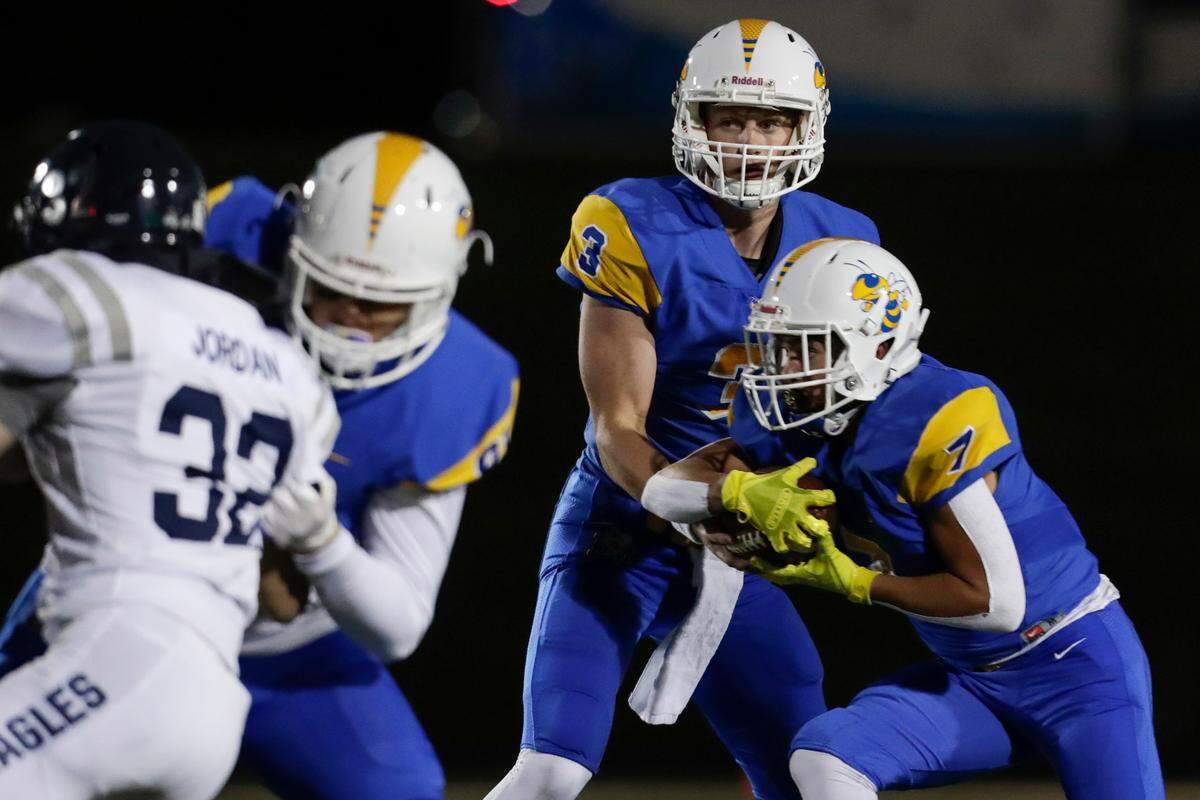 Fort Mill quarterback #3 Kyle Neibch hands the ball to #7 Will Alvarado as Fort Mill hosts Clover in Friday night Varsity football, 10-2-2020.