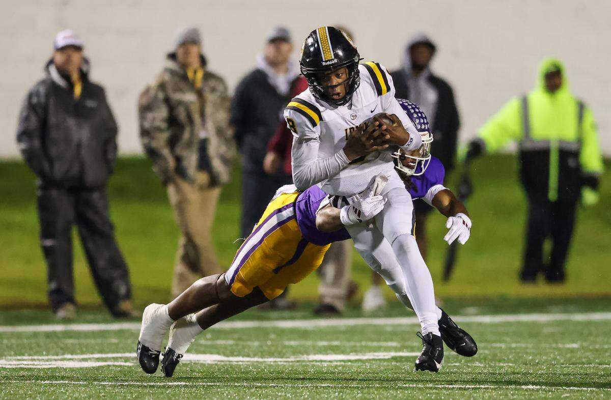 Drevon Dopson (8) of Irmo gets wrapped up by Tamarion Watkins (1) of Northwestern during the SCHSL Class 5A Division II championship game earlier this month. 