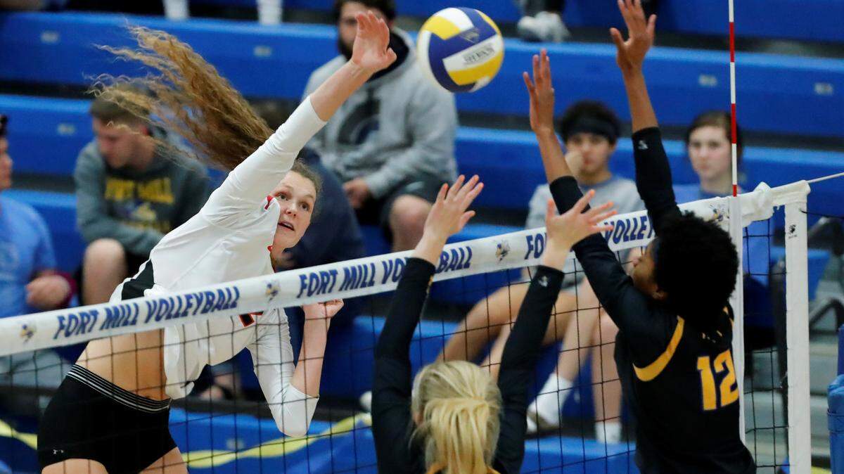 Nation Ford’s #12 Sophie Fischer spikes the ball past the Fort Mill front line as Nation Ford sweeps Fort Mill in varsity volleyball on Thursday, Oct. 17, 2019.