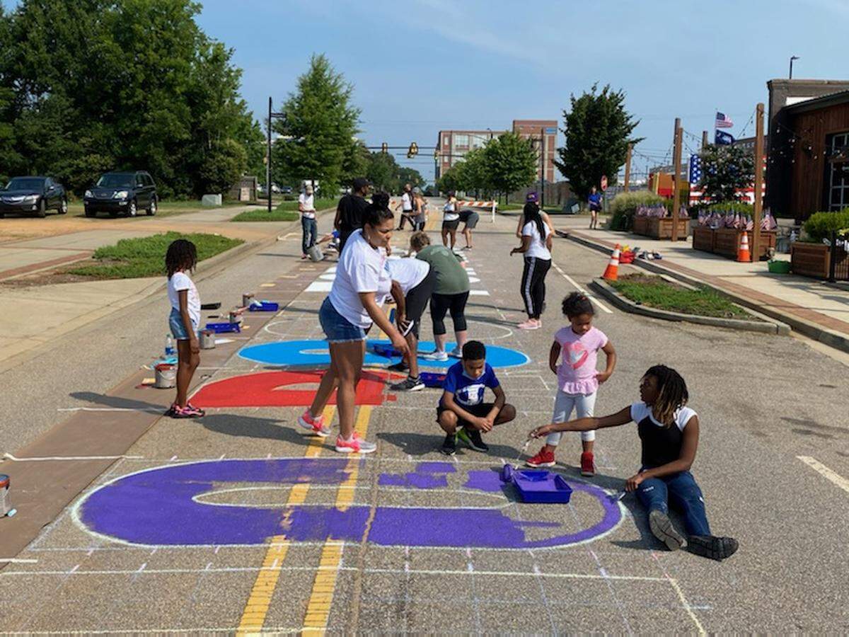 Several families came to The Mercantile on White Street last year to help paint the street mural that reads “No Room For Racism” and honors the Friendship Nine. The mural is still visible in downtown Rock Hill today.