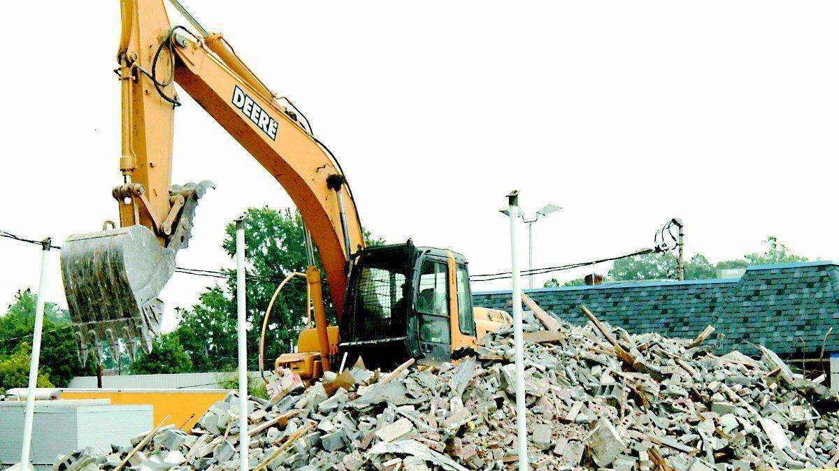 Olson Development tore down the old Post Office building at the corner of Springs and Tom Hall streets over the weekend to make way for a new three-story building.