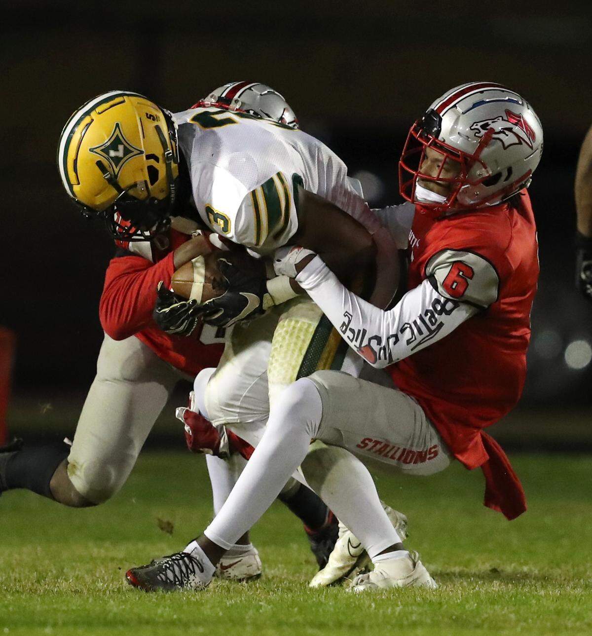 South Pointe hosted Laurens in the second round of the state playoffs November12, 2021. South Pointe’s Jaylen Stratford, left, and Quan Peterson, right take down Jayden McGowan of Laurens. Andy Burriss-Special to The Herald